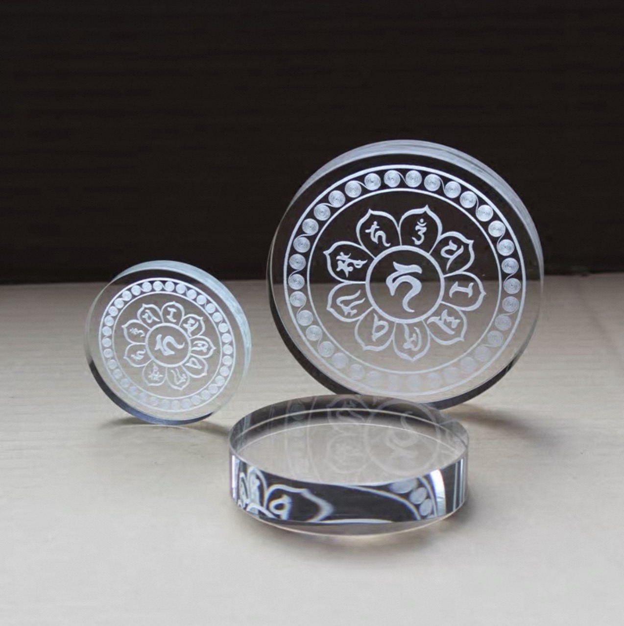 Close-up of a 100mm circular K9 crystal block showing perfect clarity and beveled edge detail.