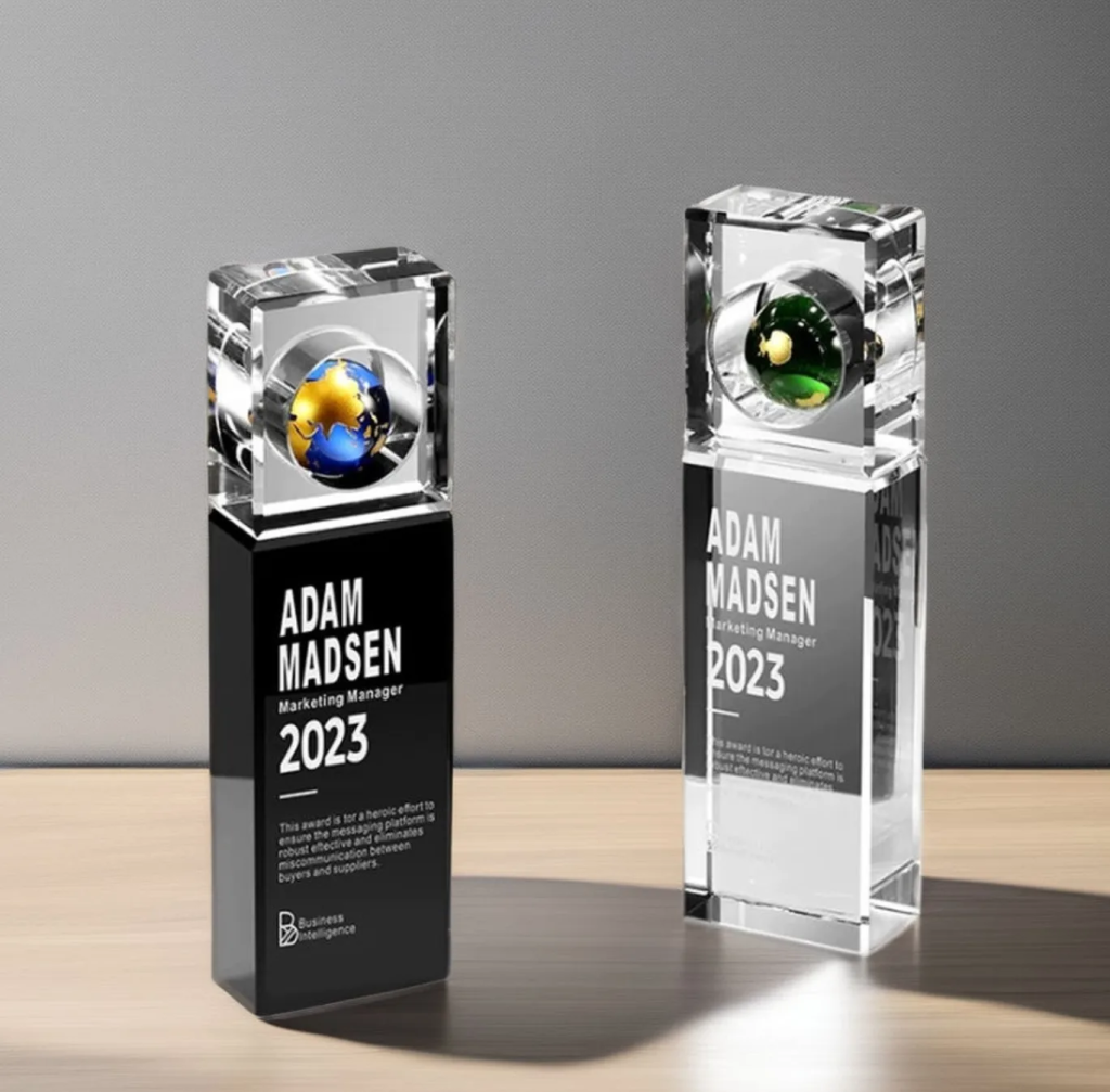 2026 custom black and clear crystal globe trophies with blue and green crystal earth tops, engraved black bases and clear crystal columns
