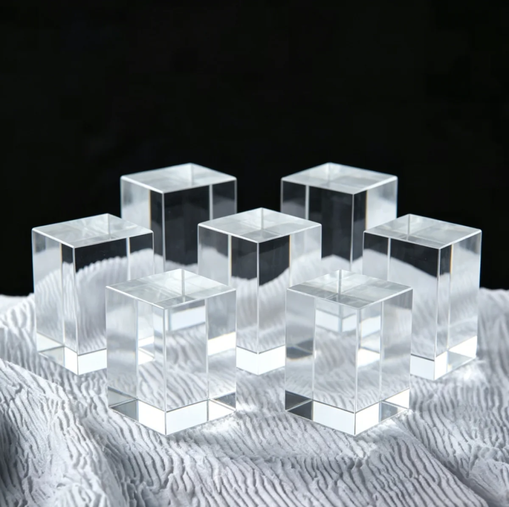 Clear 40x40x60mm K9 optical crystal rectangular blocks arranged on white fabric for xTool laser engraving
